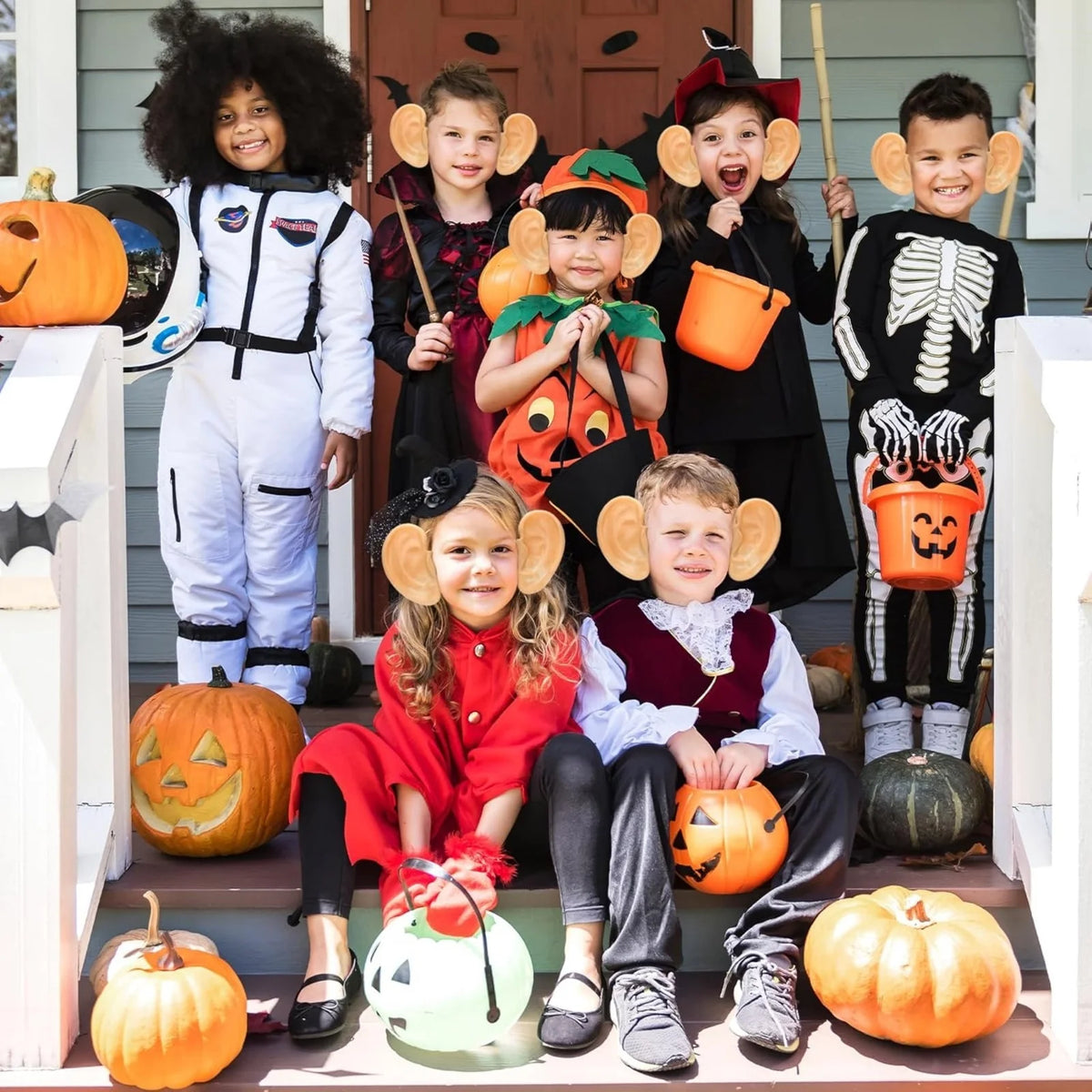Group Halloween costume photo showing oversized ear headbands worn on a porch