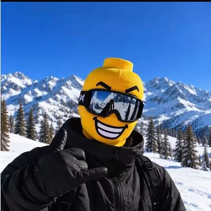 White-toothed Funny Brickhead Ski Mask shown with a black winter outfit and mountain scenery