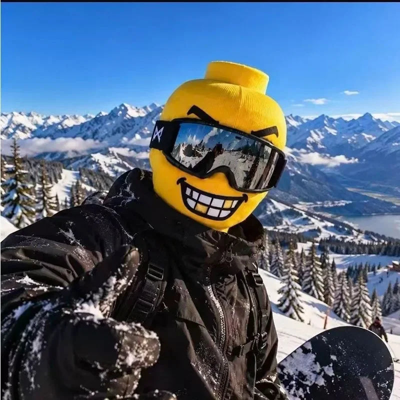 Gold-toothed Funny Brickhead Ski Mask worn by a snowboarder posing with a thumbs-up outdoors