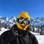 Tongue-out Funny Brickhead Ski Mask styled with a black ski jacket and goggles for a mountain photo