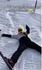 Tongue-out Funny Brickhead Ski Mask worn by a person lying in the snow and giving a thumbs-up