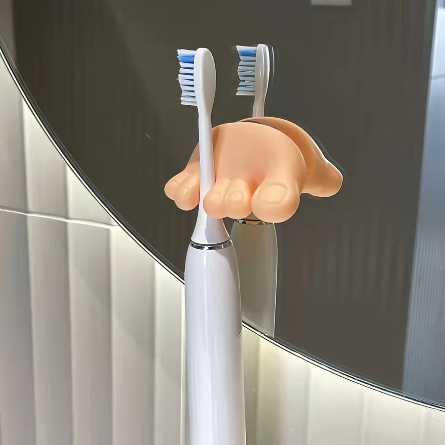 Funny Feet Toothbrush Holders securing two electric toothbrushes against a round bathroom mirror