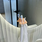 Funny Feet Toothbrush Holders supporting two electric toothbrushes and a white washcloth by a mirror