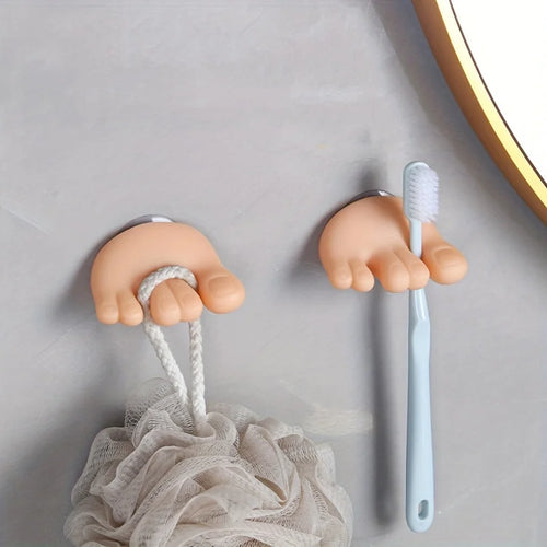 Funny Feet Toothbrush Holders mounted as a pair with a blue toothbrush and shower-puff loop
