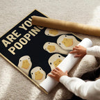 Funny Goose Bathroom Sign unframed canvas being unrolled on a light carpet beside a cardboard tube