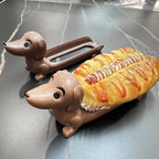 Funny Hot Dog Tray pair on a dark counter holding a hot dog and a baked pastry.