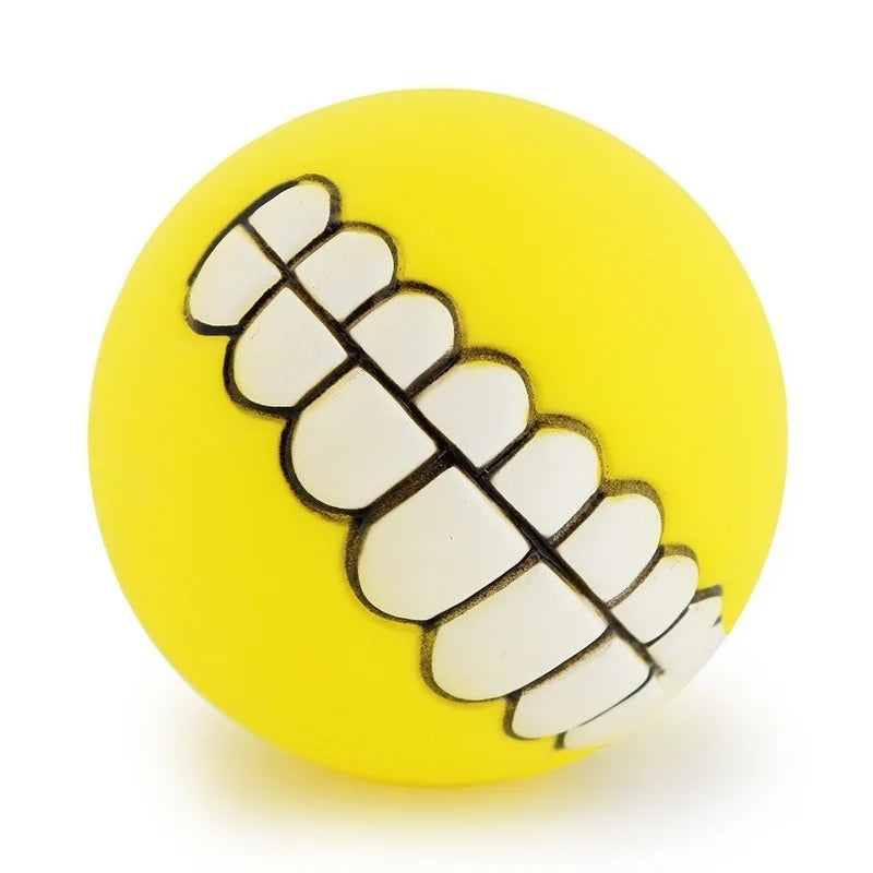 Funny Teeth Dog Balls yellow ball shown at an angle with the white toothy grin facing forward.