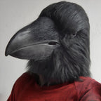 Giant Crow Head Mask in black, showing the oversized beak and shaggy head covering above a red sweater.