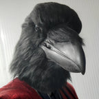 Giant Crow Head Mask in a front three-quarter portrait showing the broad beak and shaggy black crown.