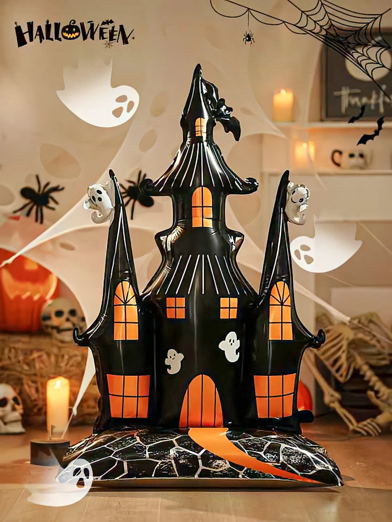 Giant Haunted House Balloon in an indoor Halloween scene with ghosts, spiders, candles, and cobwebs