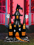 Giant Haunted House Balloon standing outside a red-lit Halloween porch with pumpkins and cobwebs