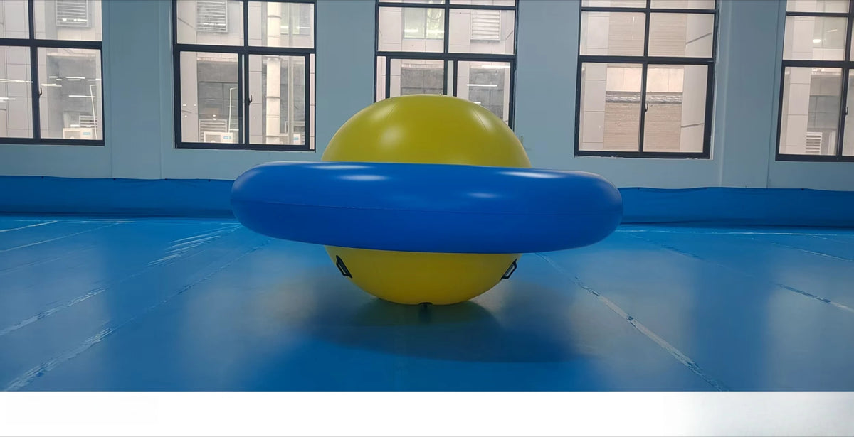 Giant Inflatable Dome Rocker in blue and yellow shown from the side on an indoor blue floor