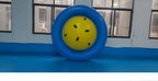 Giant Inflatable Dome Rocker standing upright on its blue outer ring to show the yellow center and handles