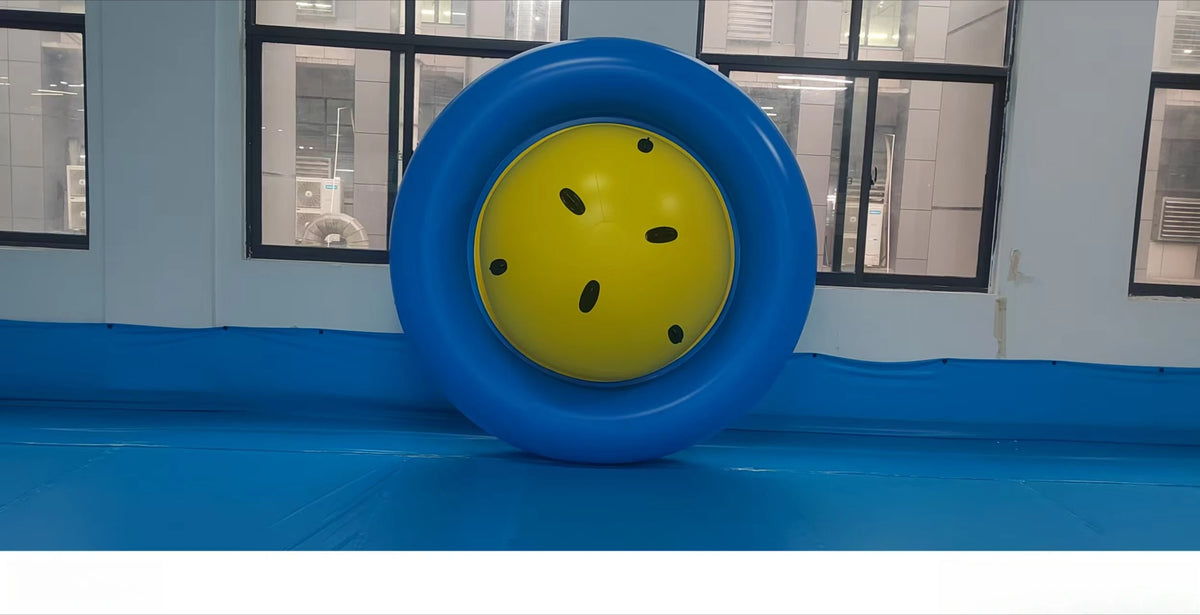 Giant Inflatable Dome Rocker standing upright on its blue outer ring to show the yellow center and handles