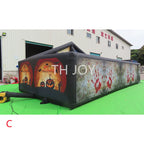 Giant Inflatable Haunted Maze with orange pumpkin and gray blood-print exterior walls outdoors
