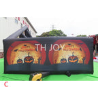 Giant Inflatable Haunted Maze orange pumpkin end wall shown in an outdoor manufacturing display