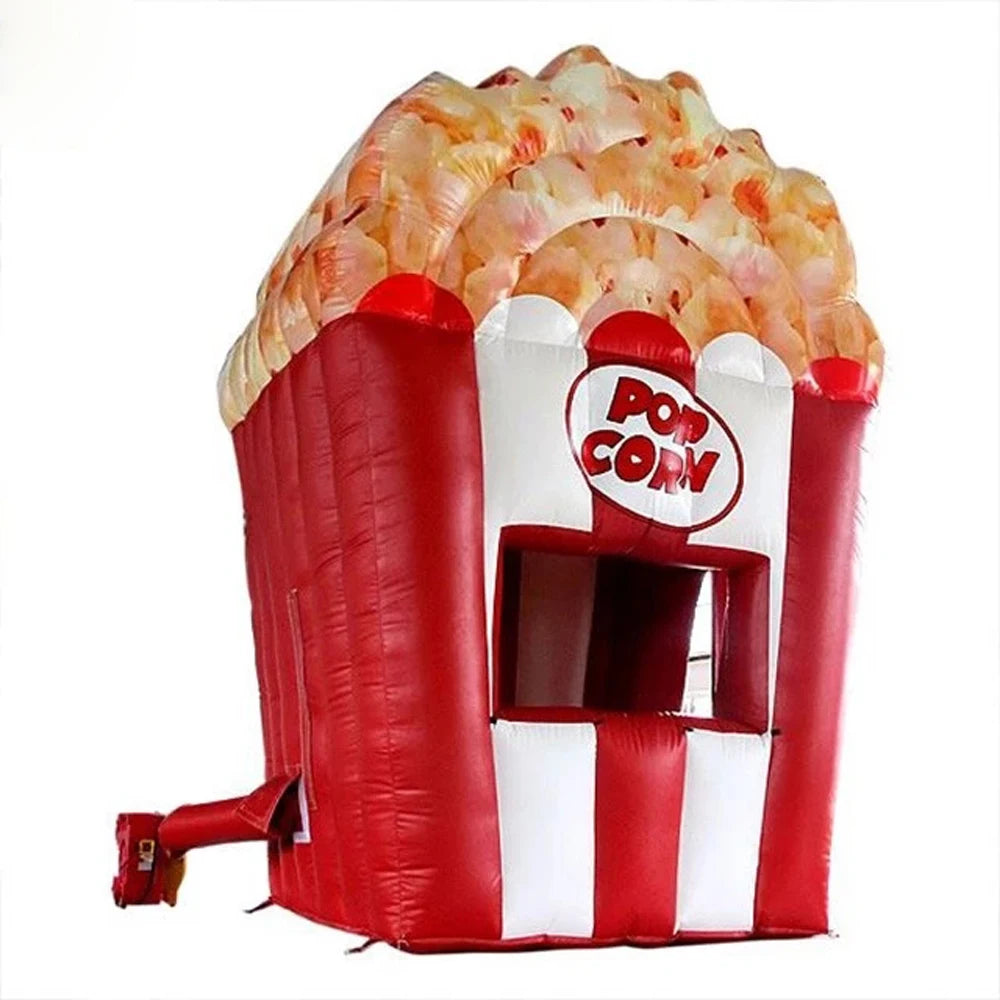 Red and white giant inflatable popcorn stand with a serving window, popcorn-shaped top and blower at the side.
