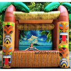 Giant Inflatable Tiki Bar frontal view with a person behind the counter and an island beach backdrop