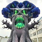 Close-up of the inflatable tree monster face with green eyes and pointed green teeth