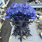 Overhead rear view of the inflatable tree monster showing its blue crown and spreading roots