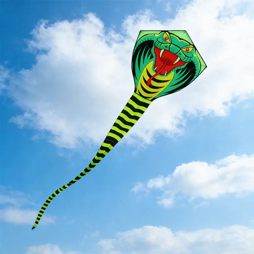 Giant Snake Kite captured from an angled view against bright clouds with its cobra face and long tail visible