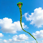 Giant Snake Kite shown at full length against a bright blue sky filled with large white clouds