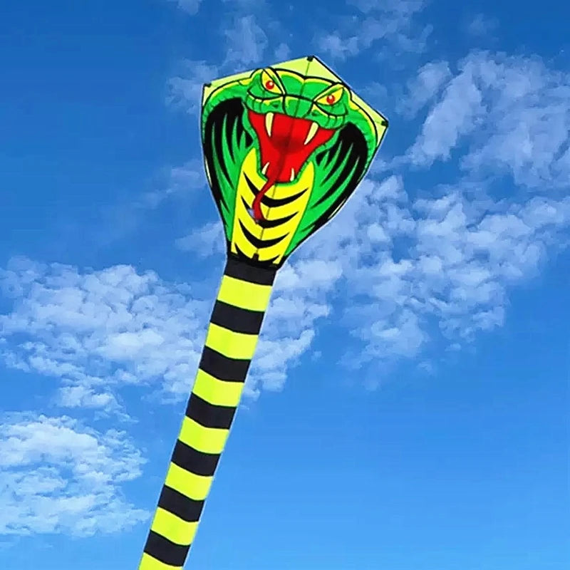 Giant Snake Kite cobra head shown close up against a blue sky with detailed green, red, and yellow artwork