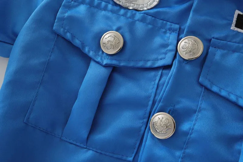 Girls Police Costume Set close-up of blue chest pockets, stitching, and embossed silver-colored buttons.