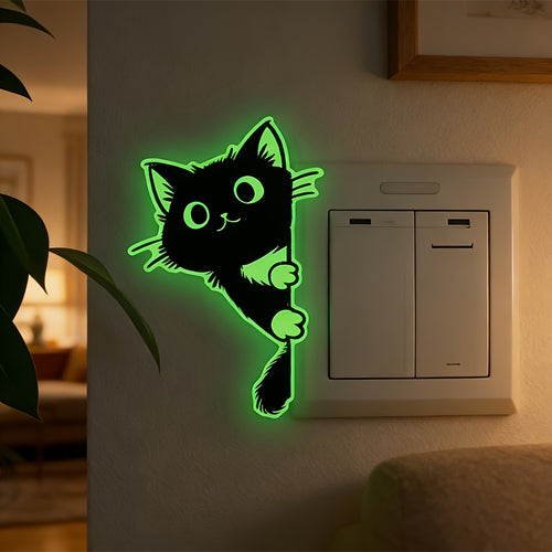 Glow Guide Cat Sticker glowing green beside a light switch in a warmly lit living room