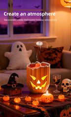 Glowing Pumpkin Humidifier on a Halloween coffee table with jellyfish mist, pumpkin lights and a ghost cushion.