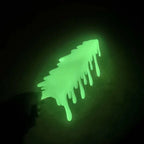 Glowing Slime Shelf Drips — Handheld green topper against a dark background, showing the top surface and hanging drips.