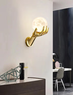 Golden Hand Wall Lamp — Moon shade above a console in a wider study-room setting