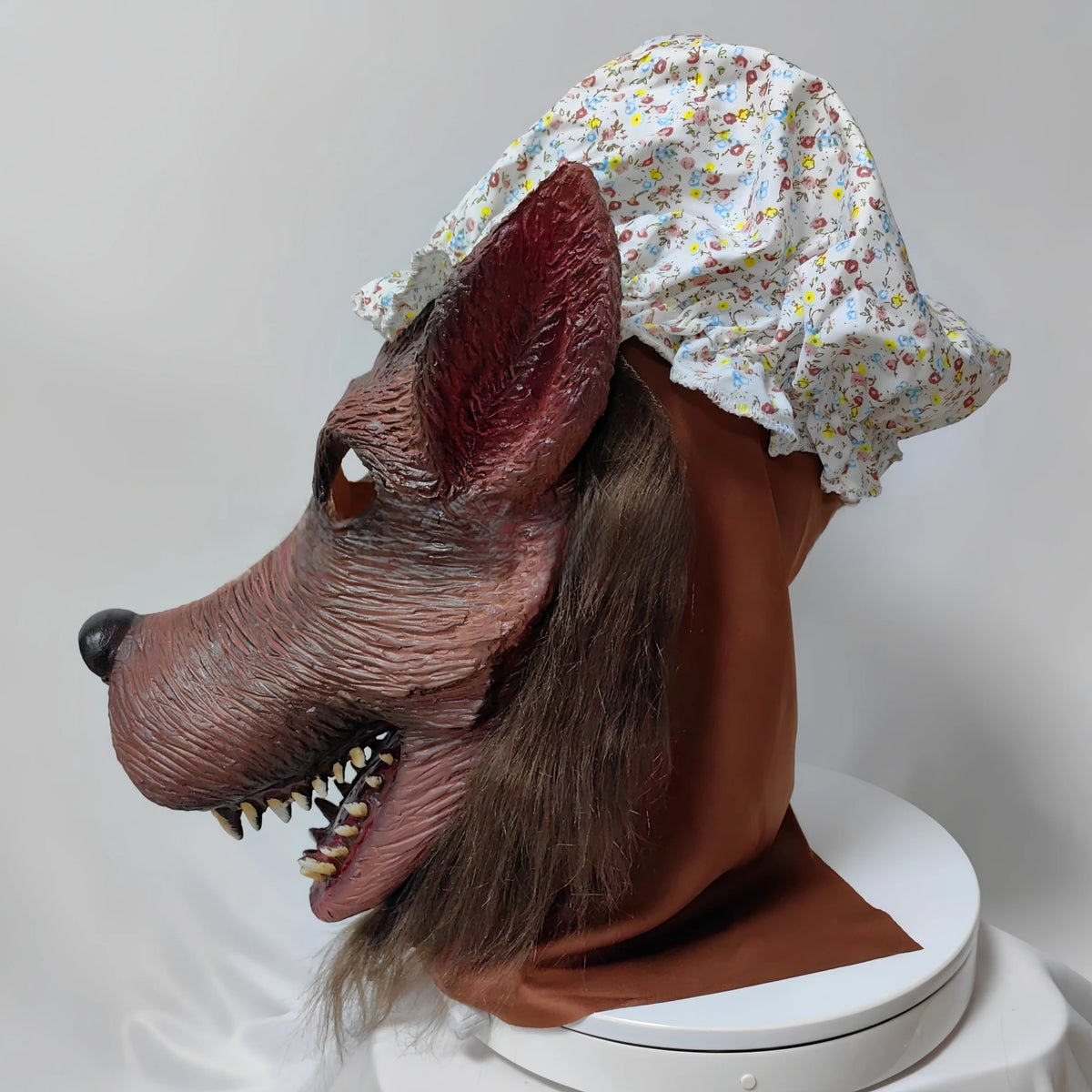 Granny Wolf Costume Mask left-side close-up of the pointed ear, floral cap and shaggy hair