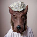 Granny Wolf Costume Mask front view worn with a white outfit, showing the floral cap and long snout