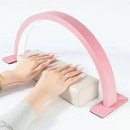 Half Moon Nail Lamp in pink illuminating decorated nails resting on a white manicure cushion.