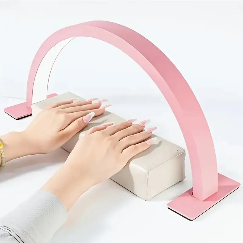 Half Moon Nail Lamp in pink illuminating decorated nails resting on a white manicure cushion.