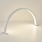 Half Moon Nail Lamp white arch on a pale tabletop with the power cable extending from its right base.