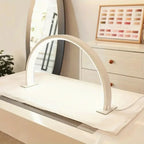 Half Moon Nail Lamp in white on a salon desk with a nail colour chart displayed in the background.