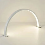 Half Moon Nail Lamp in white with an illuminated arch and two flat bases on a light desktop.