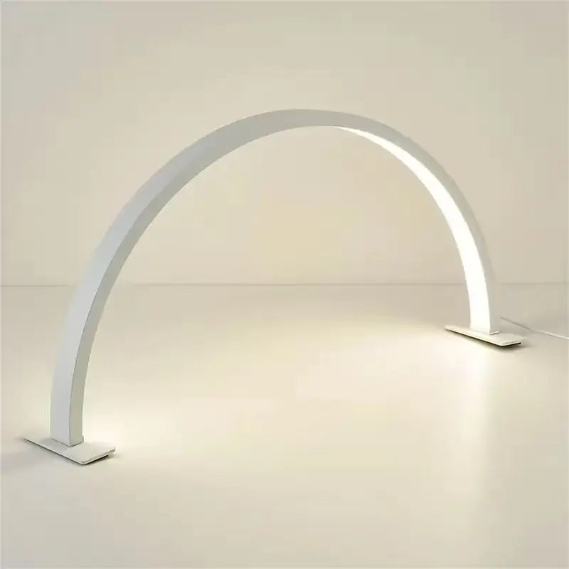 Half Moon Nail Lamp in white with an illuminated arch and two flat bases on a light desktop.