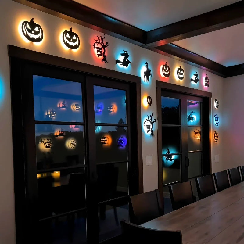 Halloween 3D Wall Lights framing dining room windows with illuminated pumpkins, ghosts, witches and trees.