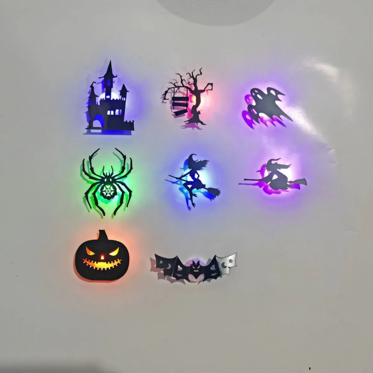 Halloween 3D Wall Lights showing eight designs, including a castle, ghosts, witches, spider, pumpkin and bat.