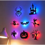 Halloween 3D Wall Lights in an eight-design arrangement beside a desk lamp, with vivid blue and red glows.