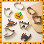Halloween Cookie Cutter Set arranged with decorated cookies and rolled dough on a wooden board.