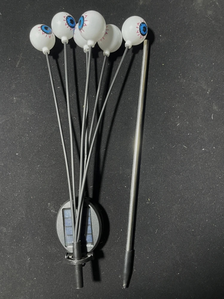 Unlit Halloween eyeball stake light with six eyes, flexible stems, solar panel and detached ground spike
