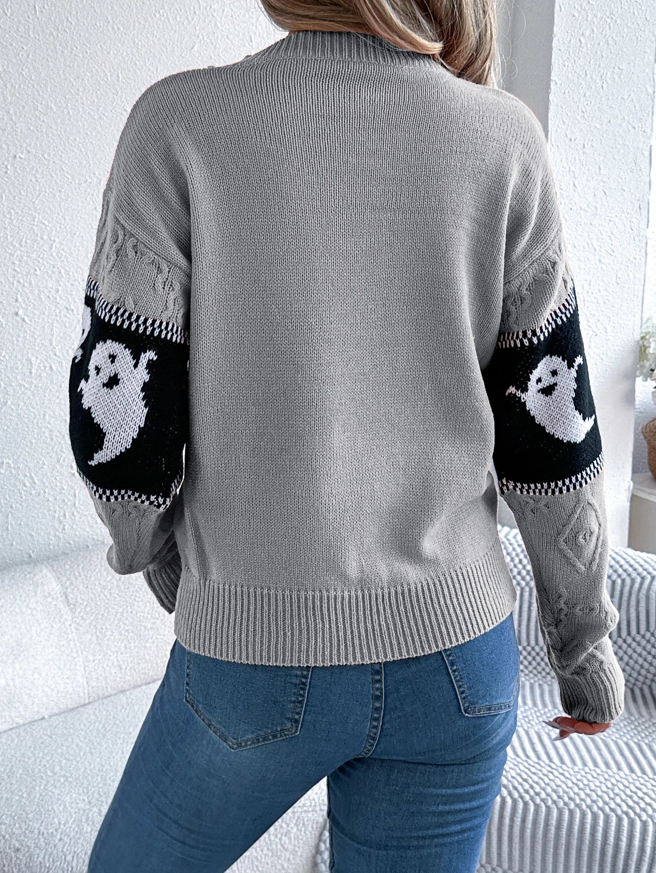Halloween Ghost Knit Sweater gray back view showing plain knit body and ghost-pattern sleeve stripes