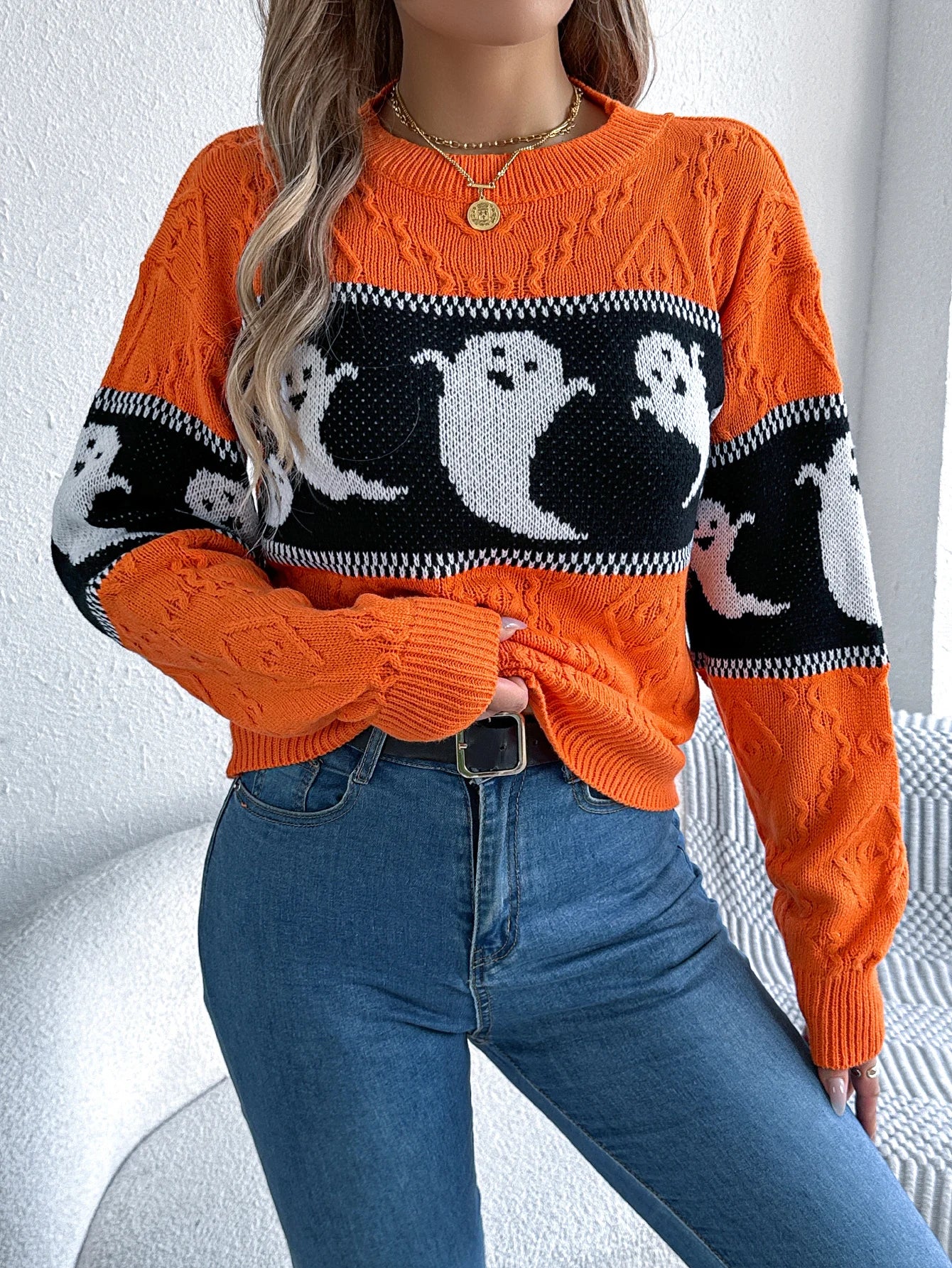 Halloween Ghost Knit Sweater in orange with black contrast stripe and white ghosts, front view
