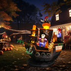 Halloween pirate ship inflatable glowing beside a home in a decorated front-yard nighttime scene