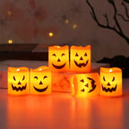 Halloween Pumpkin LED Candle Set: six glowing candles arranged on a table and riser, with one on its side.