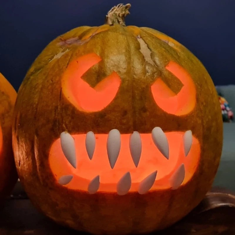 Halloween Pumpkin Teeth Inserts sharp fangs in an illuminated pumpkin with an uneven monster grin